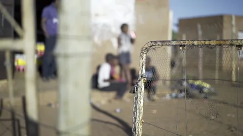 In focus chicken wire gate with chain and padlock with blurred background Stock Footage 138415078
