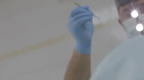 Focus in on close up of dentist with mask working on patient. Stock Footage 61378204