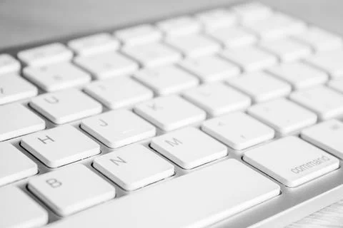 Focus on computer keyborad button on a wooden table. Stock Photos