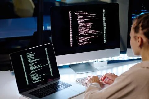 Focus on computer screen with coded data while IT engineer working in front Stock Photos