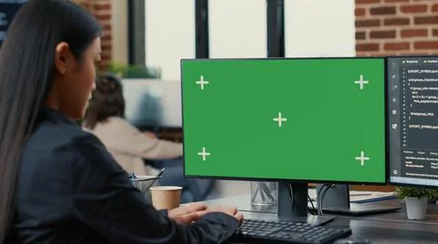 Focus on computer screen with green screen chroma key mockup in front of asian 写真素材