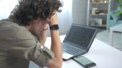 Focus on computer, Young man disappointed for failed strategy of trading Stock Footage 168531288