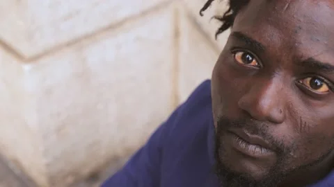 Focus on despair, depression. Young African man despairing in the street Stock Footage 218616564