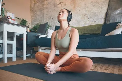 Focus on developing a connection between the body and the breath. a young woman Stock Photos