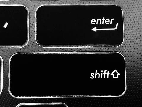 Focus on Enter and Shift keys on a modern laptop keyboard. Stock Photos