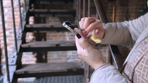 Focus on Female Hand Using Smartphone. Woman Holding Mobile Phone, Posting Stock Footage 256203220