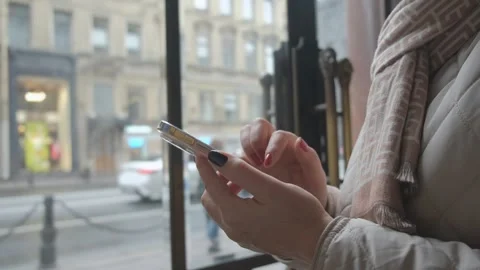 Focus on Female Hand Using Smartphone. Woman Holding Mobile Phone, Posting Stock Footage 256671503