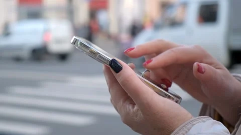 Focus on Female Hand Using Smartphone. Woman Holding Mobile Phone, Posting Stock Footage 259533807