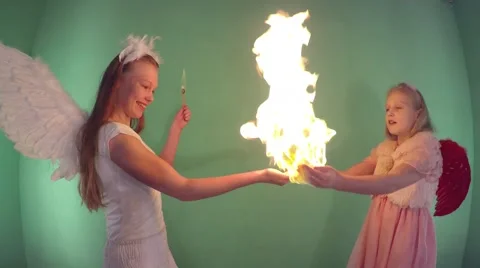 Focus fire. Two beautiful girls dressed as an angel. 動画素材 59661255