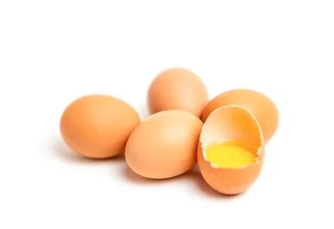 Focus fresh egg yolk in the shell on isolate white background. Stock Photos