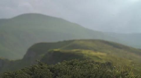 Focus from Grass to Mountain Range 4K Stock Footage 64209974