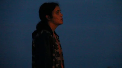 Focus in on gun which is being held by a girl Stock Footage 114262007