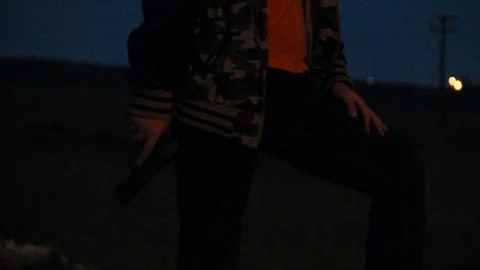 Focus in on gun which is being held by a kid Stock Footage 114262020