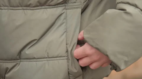 Focus on insulated padded jacket with hidden hand pockets. Zoomedin shot Stock Footage 345527411
