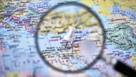 Focus on Jerusalem on a map with a magnifying glass Stock Photos