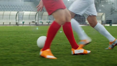 Focus on Legs of a Professional Soccer Player Leading with a Ball, Masterfully Stock Footage