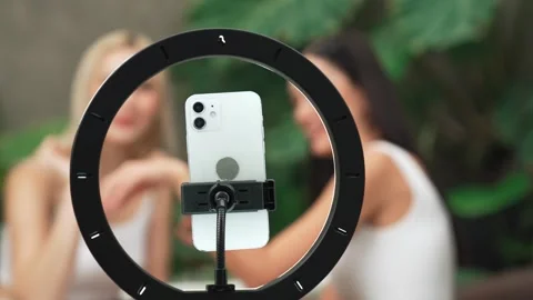 Focus light ring with phone camera live streaming two beauty blogger. Blithe Video stock 277355056