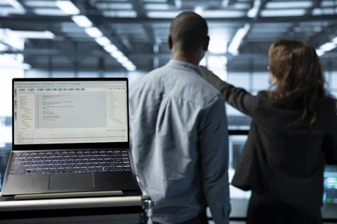 Focus on lines of code on laptop screen used by data center engineers Foto stock