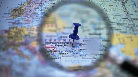 Focus on a location on a Dnipro map with a magnifying glass and a pushpin Stock Photos