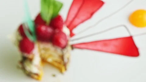 Focus in macro at sliced mousse raspberry dessert on white plate Stock Footage 121471238