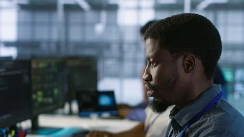 Focus on man in server hub office using artificial intelligence Stock Photos