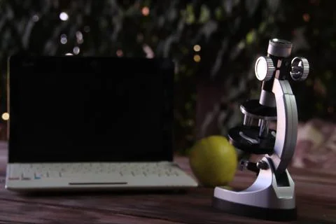 Focus on a microscope standing on a table. Stock Photos