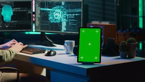 Focus on mockup tablet next to programmer updating artificial intelligence Stock Photos