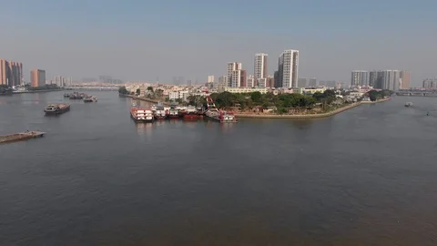 The focus is on moored barges on a navigable river in a big city. Stock Footage 118211200