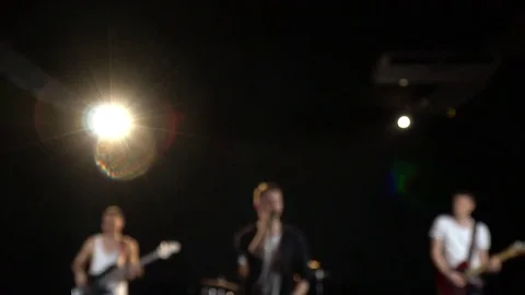 Focus on a musical group from the vocalist, guitarists and drummer, slow motion Stock Footage