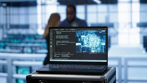 Focus on notebook used by engineers in server hub in blurry background Foto stock