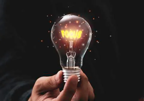 Focus objective target concept,Hand holding lightbulb Stock Photos