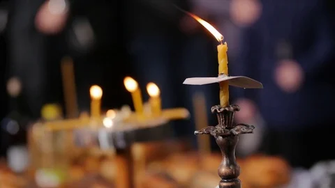 Focus from one candle to many, in slow motion Stock Footage 84306245