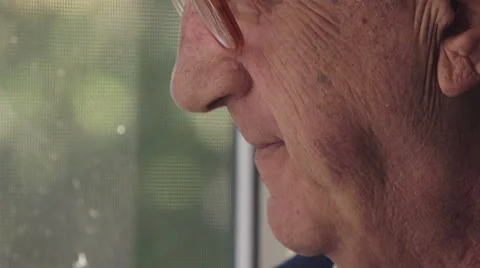 Focus on pensioner while smokes at the window Video stock 63419071