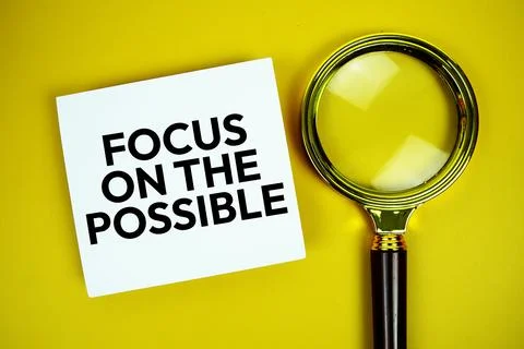 Focus On The Possible text message written on paper note with magnifying gl.. Stock Photos