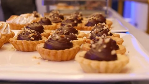 Focus pull across chocolate tarts Stock Footage 81259711