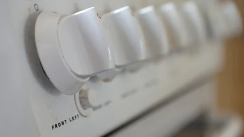 Focus pull close up across residential cooker temperature knobs, slightly 動画素材 108855200