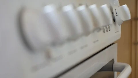 Focus pull close up across residential cooker temperature knobs, slightly Video stock 108855205