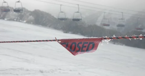 Focus Pull to Closed Sign Barrier at Top of Ski Run In Winter Covid 19 Shutd Stock Footage 137848156