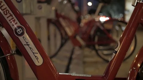 Focus Pull on Downtown Austin Bicycle Rental Docking Station at Night Stock Footage 73974437
