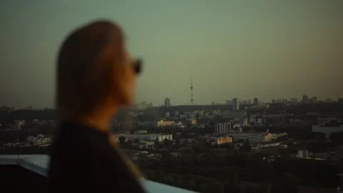Focus pull from the evening Kiev city Ukraine TV tower through the silhouette of Stock Footage 279984053