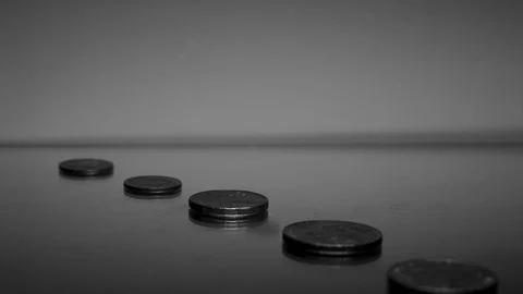 Focus pull of five coins on mirror Stock Footage 87796787