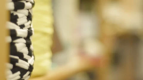 Focus Pull to Foreground Across a Shelf of Yarn Stock Footage 57268589