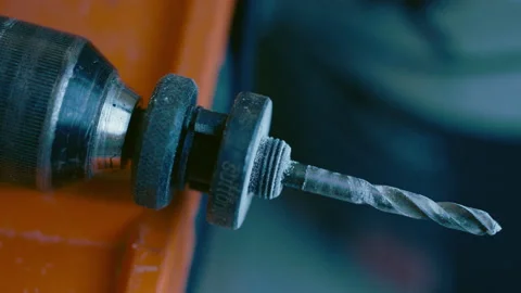 Focus pull on a hand drill to a bucket of  construction compound Stock Footage 165439749