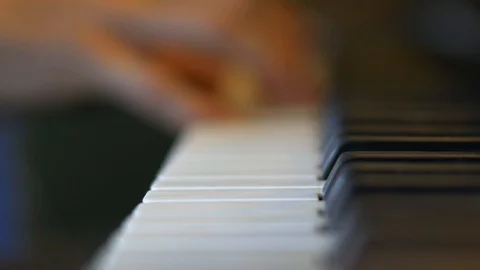 Focus pull to hand playing a grand piano Stock Footage 102734899