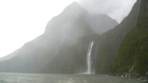 Focus pull from heavy rain to a waterfall Stock Footage 93781655