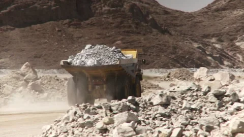 Focus pull of a loaded dump truck driving through an opencast mine Stock Footage 312400444