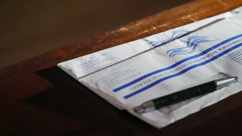 Focus pull of mail in voting ballot envelopes in 2020 US presidential election Stock Footage 141461965