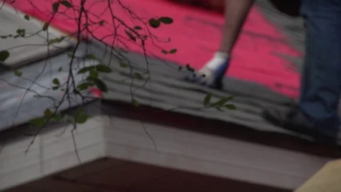 Focus Pull of Man on Roof Nailing Shingles Slow Motion 動画素材 85364916