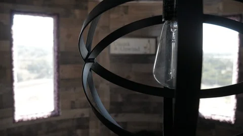 Focus Pull from Modern Light Fixture to Uncork and Unwind Sign Video stock 122230218