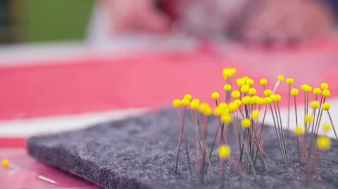 Focus pull from needles to scissors cutting in slow motion Stock Footage 41013892